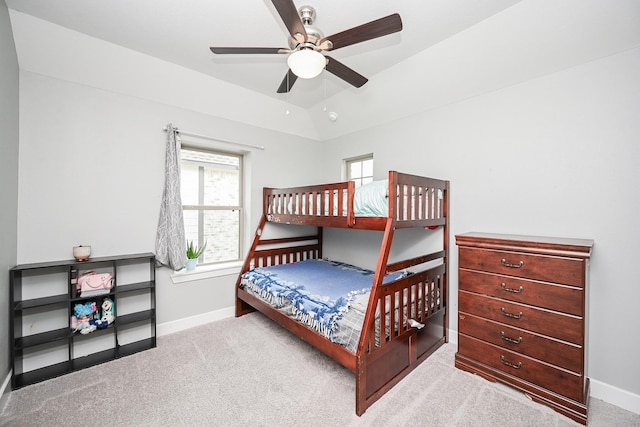 bedroom with vaulted ceiling, baseboards, and carpet
