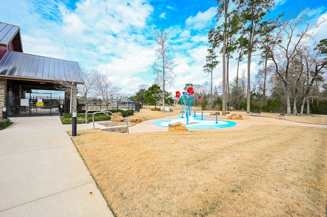 view of home's community featuring a gate, fence, and a yard