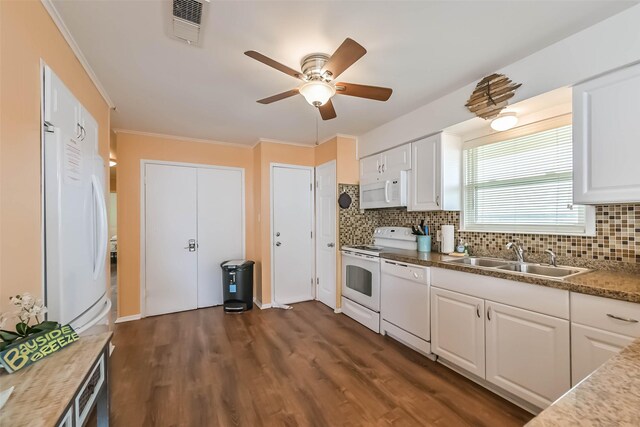 kitchen featuring visible vents, ornamental molding, white appliances, a sink, and decorative backsplash