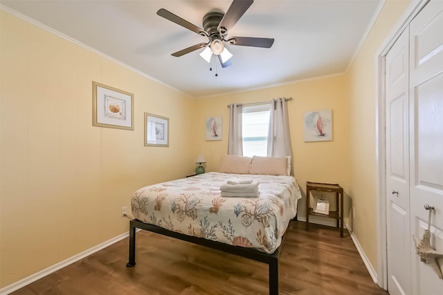 bedroom featuring wood finished floors, baseboards, and ornamental molding