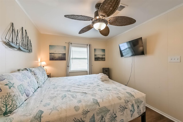 bedroom featuring ceiling fan, baseboards, crown molding, and dark wood-style floors