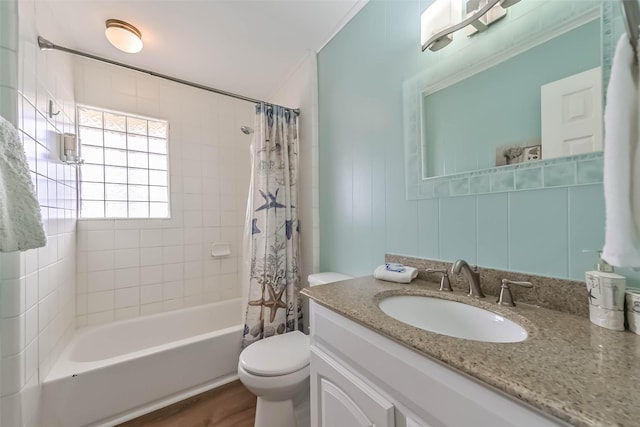 bathroom with shower / tub combo, toilet, ornamental molding, and vanity