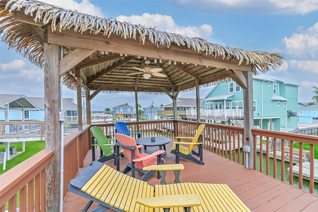 wooden deck featuring a gazebo, a residential view, and ceiling fan