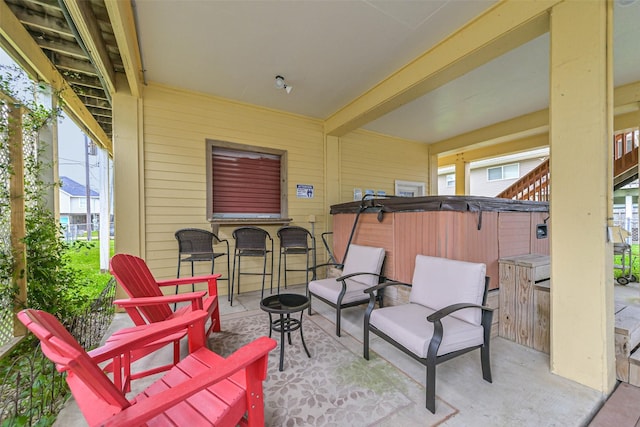 view of patio / terrace with outdoor dry bar and a hot tub