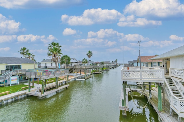 view of dock featuring boat lift, a residential view, and a water view