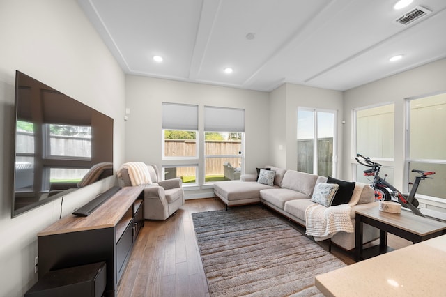 living area with recessed lighting, visible vents, and light wood-style flooring