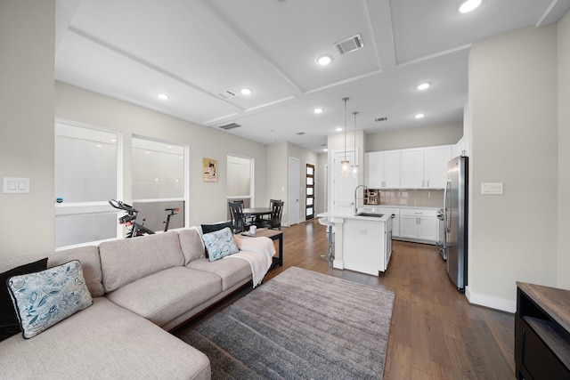 living area featuring recessed lighting, visible vents, and dark wood-style flooring