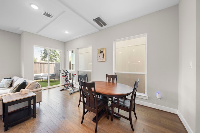 dining area featuring baseboards, wood finished floors, visible vents, and recessed lighting