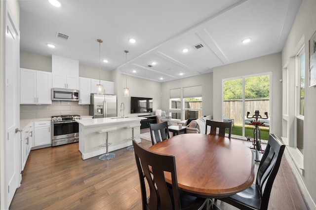 dining room with visible vents, recessed lighting, and dark wood-type flooring