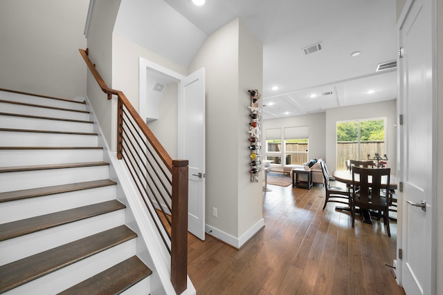 staircase featuring wood-type flooring, baseboards, visible vents, and recessed lighting