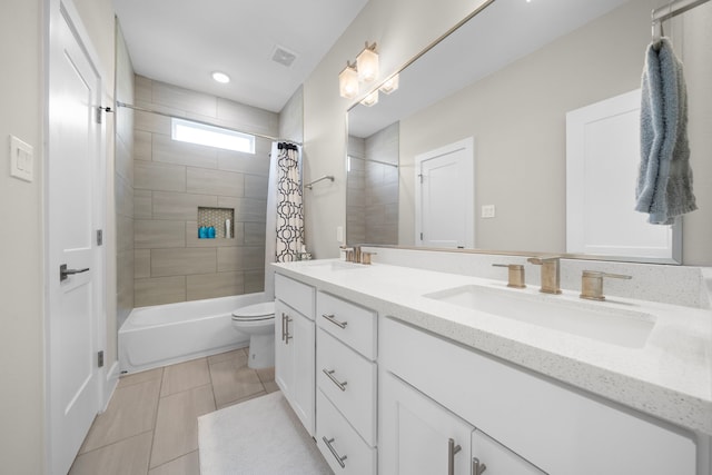 full bathroom with a sink, double vanity, visible vents, shower / bath combo with shower curtain, and tile patterned flooring
