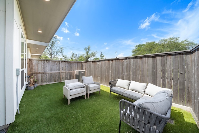exterior space with a fenced backyard, an outdoor hangout area, and central air condition unit