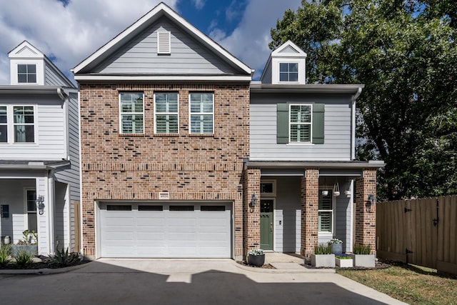 view of front of house with concrete driveway, an attached garage, brick siding, and fence