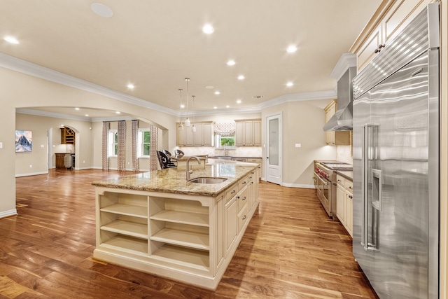 28002 Whispering Maple Way, Spring, TX 77386 - kitchen featuring high quality appliances, cream cabinets, arched walkways, a sink, and open shelves