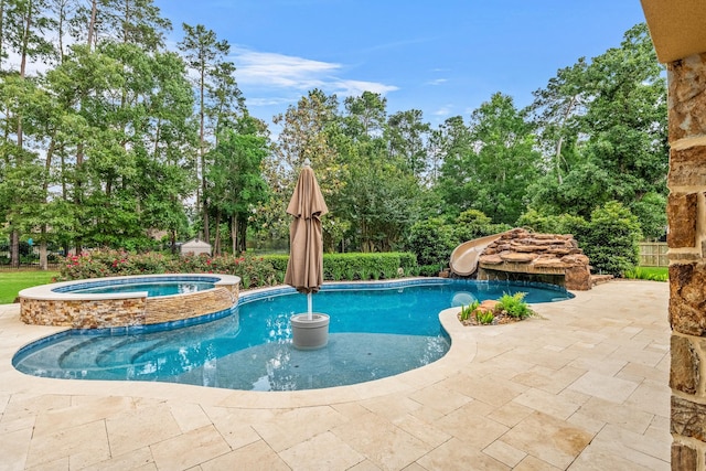 28002 Whispering Maple Way, Spring, TX 77386 - view of pool with a water slide, a patio, a pool with connected hot tub, and view of wooded area