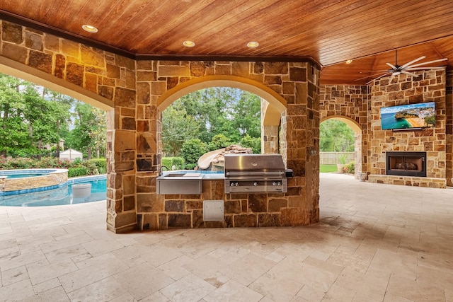 28002 Whispering Maple Way, Spring, TX 77386 - view of patio / terrace with grilling area, an outdoor kitchen, an outdoor stone fireplace, ceiling fan, and a pool with connected hot tub