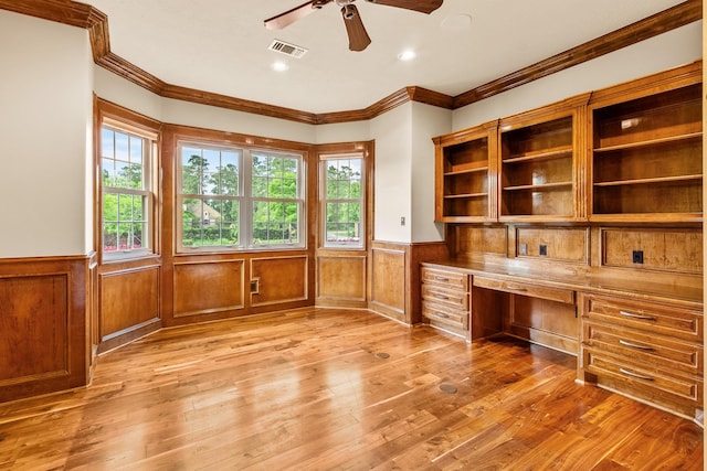 28002 Whispering Maple Way, Spring, TX 77386 - unfurnished office featuring built in study area, a wainscoted wall, ceiling fan, ornamental molding, and light wood-style flooring