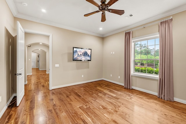 28002 Whispering Maple Way, Spring, TX 77386 - unfurnished room featuring arched walkways, ornamental molding, ceiling fan, light wood-style flooring, and baseboards