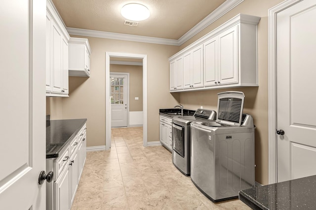 28002 Whispering Maple Way, Spring, TX 77386 - laundry area with cabinet space, washing machine and dryer, crown molding, baseboards, and a textured ceiling