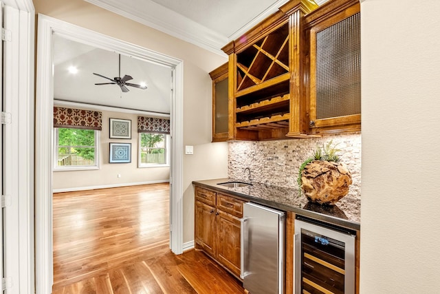 28002 Whispering Maple Way, Spring, TX 77386 - indoor bar featuring ornamental molding, wine cooler, wood finished floors, tasteful backsplash, and ceiling fan