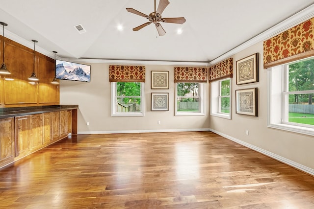28002 Whispering Maple Way, Spring, TX 77386 - unfurnished living room featuring vaulted ceiling, a ceiling fan, wood finished floors, crown molding, and baseboards