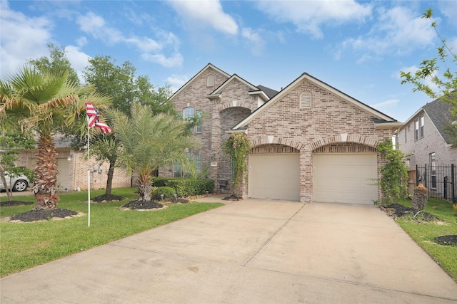 view of front facade featuring an attached garage, a front lawn, driveway, and brick siding