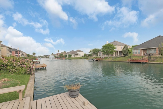 view of dock with a water view and a residential view