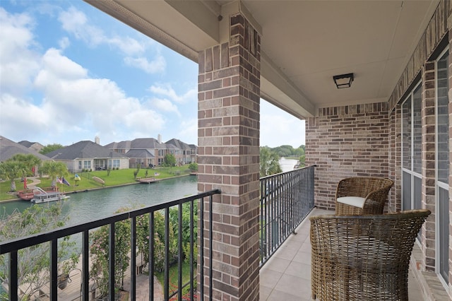 balcony featuring a water view and a residential view