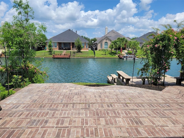 dock area featuring a yard and a water view