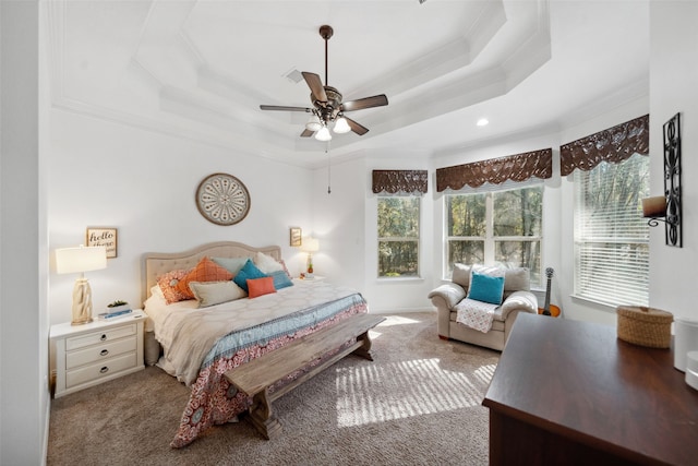 bedroom featuring a tray ceiling, recessed lighting, ceiling fan, carpet floors, and ornamental molding