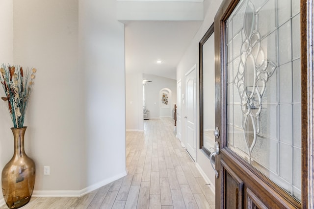 corridor featuring recessed lighting, light wood finished floors, and baseboards