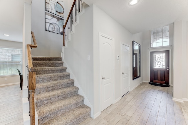 entrance foyer with stairway and light wood-style flooring