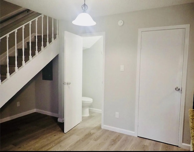 interior space with baseboards and wood finished floors
