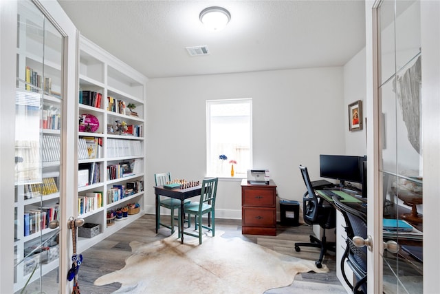 1818 Regent Mill Dr, Missouri City, TX 77459 - office area featuring wood finished floors and visible vents