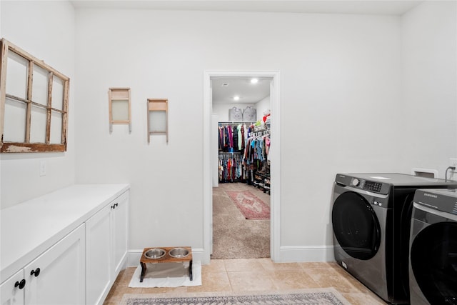 1818 Regent Mill Dr, Missouri City, TX 77459 - laundry area with washing machine and dryer, baseboards, light tile patterned floors, and cabinet space