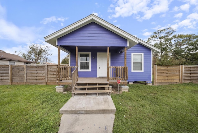 504 Stimpson St, Baytown, TX 77520 - bungalow-style home featuring a front lawn, fence, and a porch