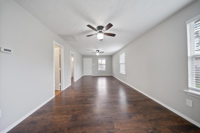 504 Stimpson St, Baytown, TX 77520 - unfurnished living room featuring wood finished floors, a textured ceiling, a ceiling fan, and baseboards