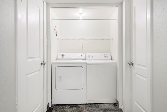 washroom featuring washing machine and clothes dryer and laundry area