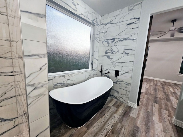 20 Lazy Spgs, Trinity, TX 75862 - bathroom with tile walls, wood finished floors, a freestanding tub, and ceiling fan