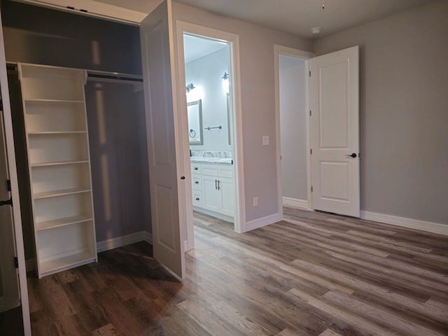 20 Lazy Spgs, Trinity, TX 75862 - unfurnished bedroom featuring baseboards, ensuite bath, and wood finished floors