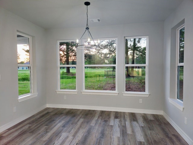 20 Lazy Spgs, Trinity, TX 75862 - unfurnished dining area with dark wood-type flooring, visible vents, baseboards, and an inviting chandelier