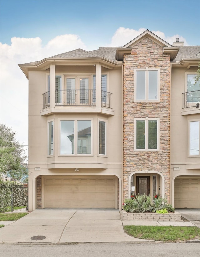 multi unit property with a garage and a balcony