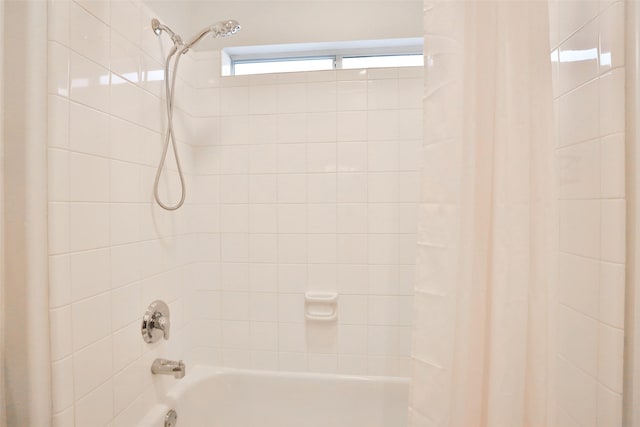 bathroom featuring shower / bath combo with shower curtain