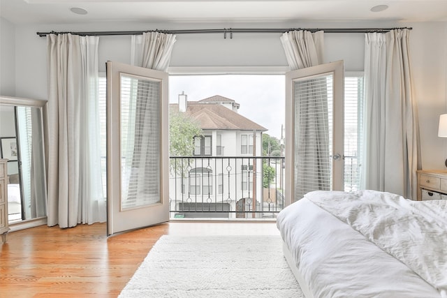 bedroom featuring access to outside and wood finished floors
