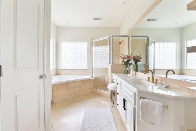 bathroom with vanity, a shower stall, a garden tub, and visible vents