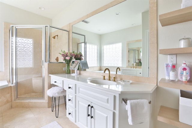 bathroom with vanity, tile patterned flooring, and a stall shower