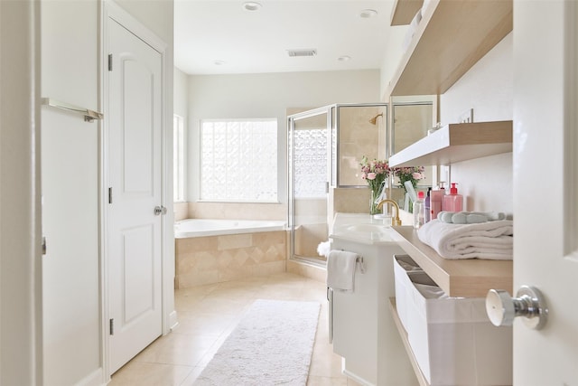 bathroom featuring tile patterned flooring, a garden tub, visible vents, and a shower stall