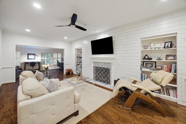 living area with a fireplace with flush hearth, wood finished floors, a ceiling fan, and recessed lighting