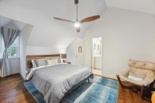 bedroom with vaulted ceiling, wood finished floors, connected bathroom, baseboards, and ceiling fan