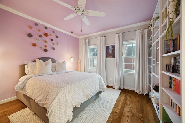 bedroom featuring ceiling fan, wood finished floors, baseboards, and ornamental molding